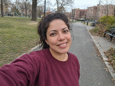 A woman taking a casual selfie in her neighborhood park